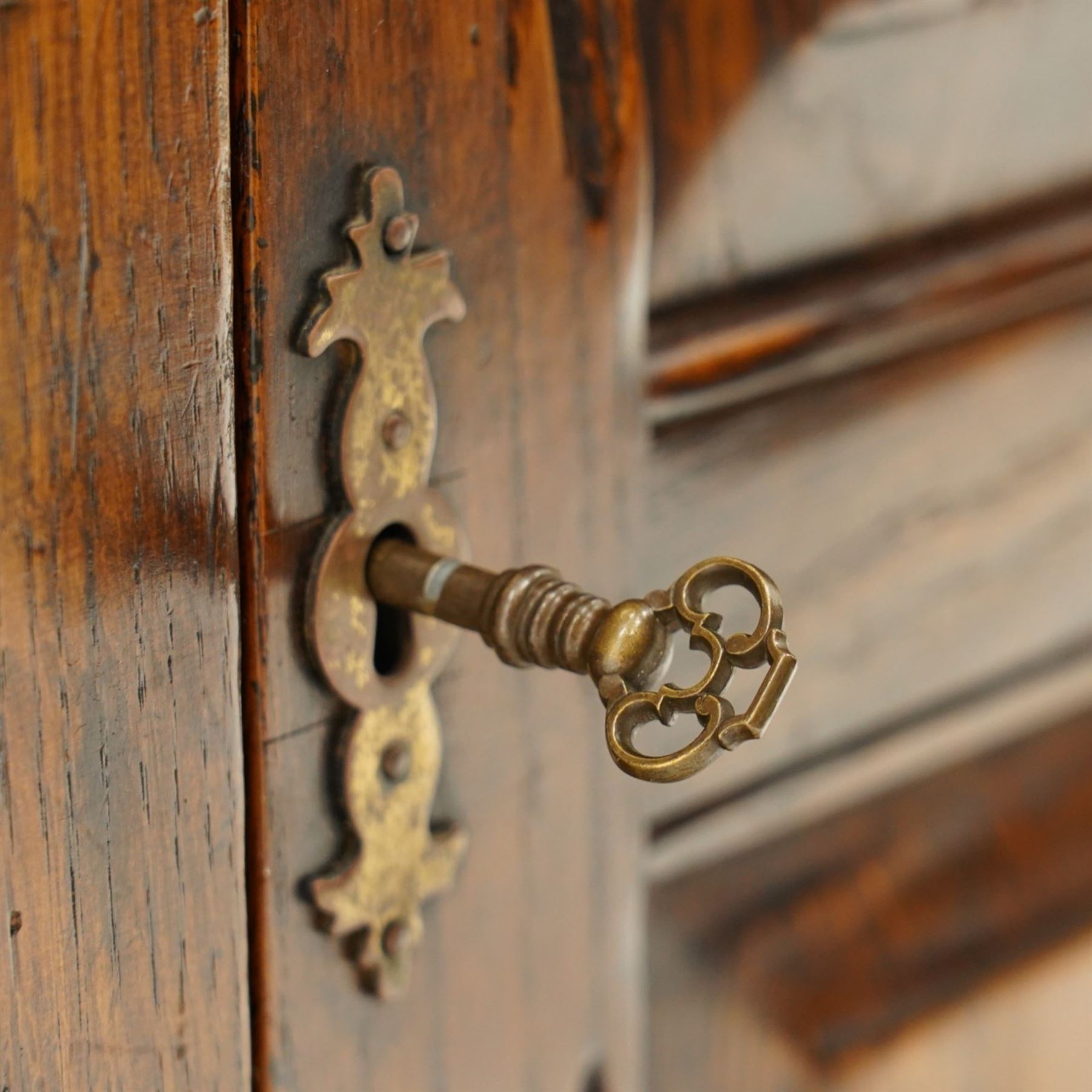 18th century style oak dresser base, rectangular moulded top over two frieze drawers with brass handles, twin panelled cupboard doors below with pierced brass escutcheons, on stile feet
