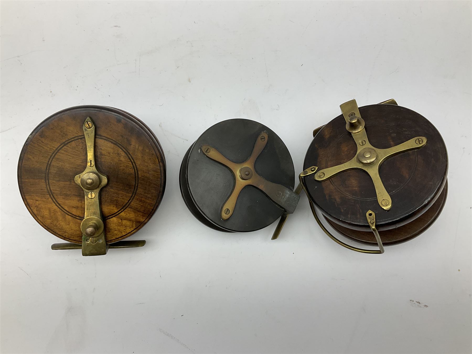 Three Allcocks & Co Ltd reels of brass and wood construction, the largest D4.5 inches