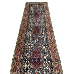 Persian Bidjar ivory ground runner, decorated with three medallions in a field of Herati motifs, three band border with overall floral design