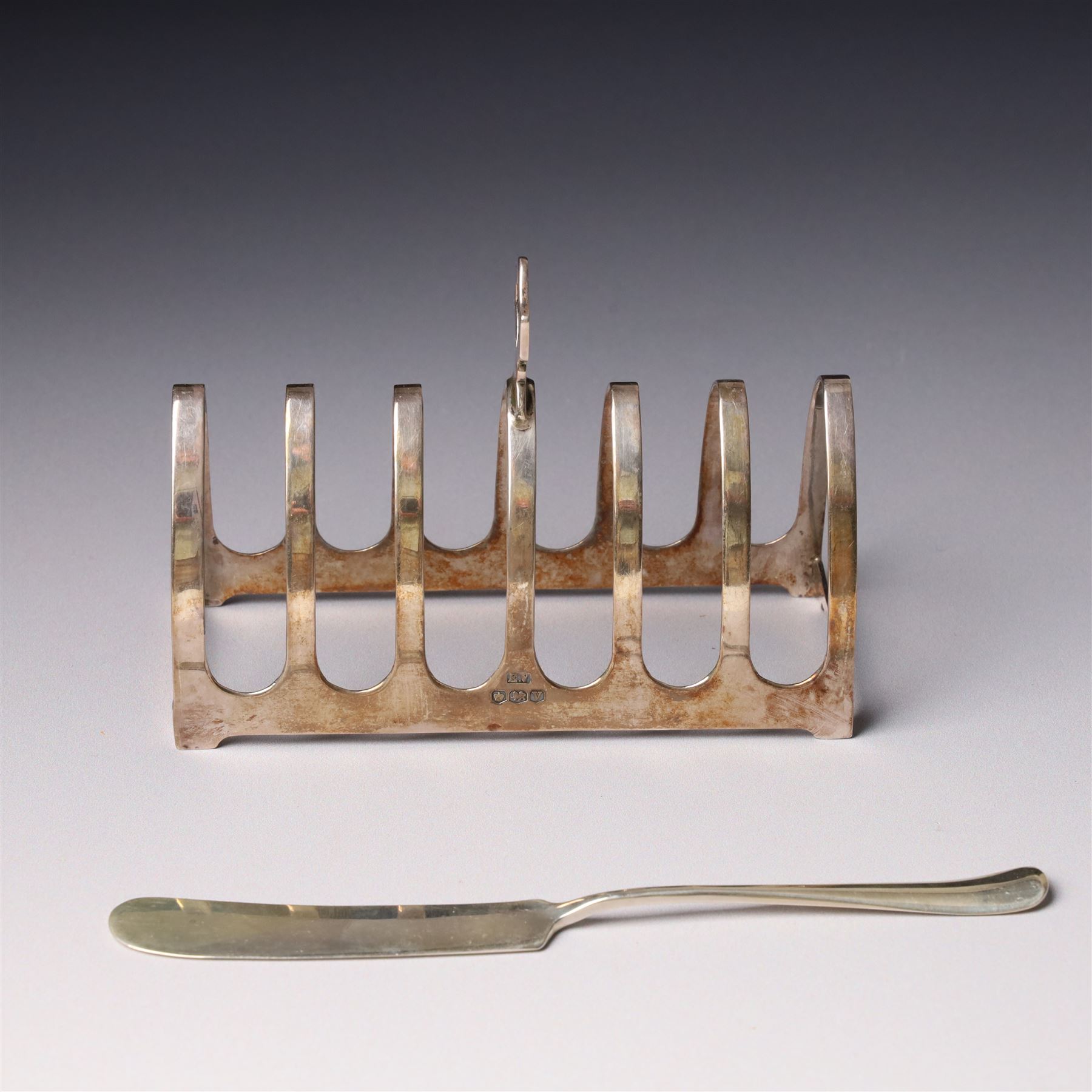 Silver six division toast rack with loop handle Sheffield 1938 Maker Viners and a silver butter knife