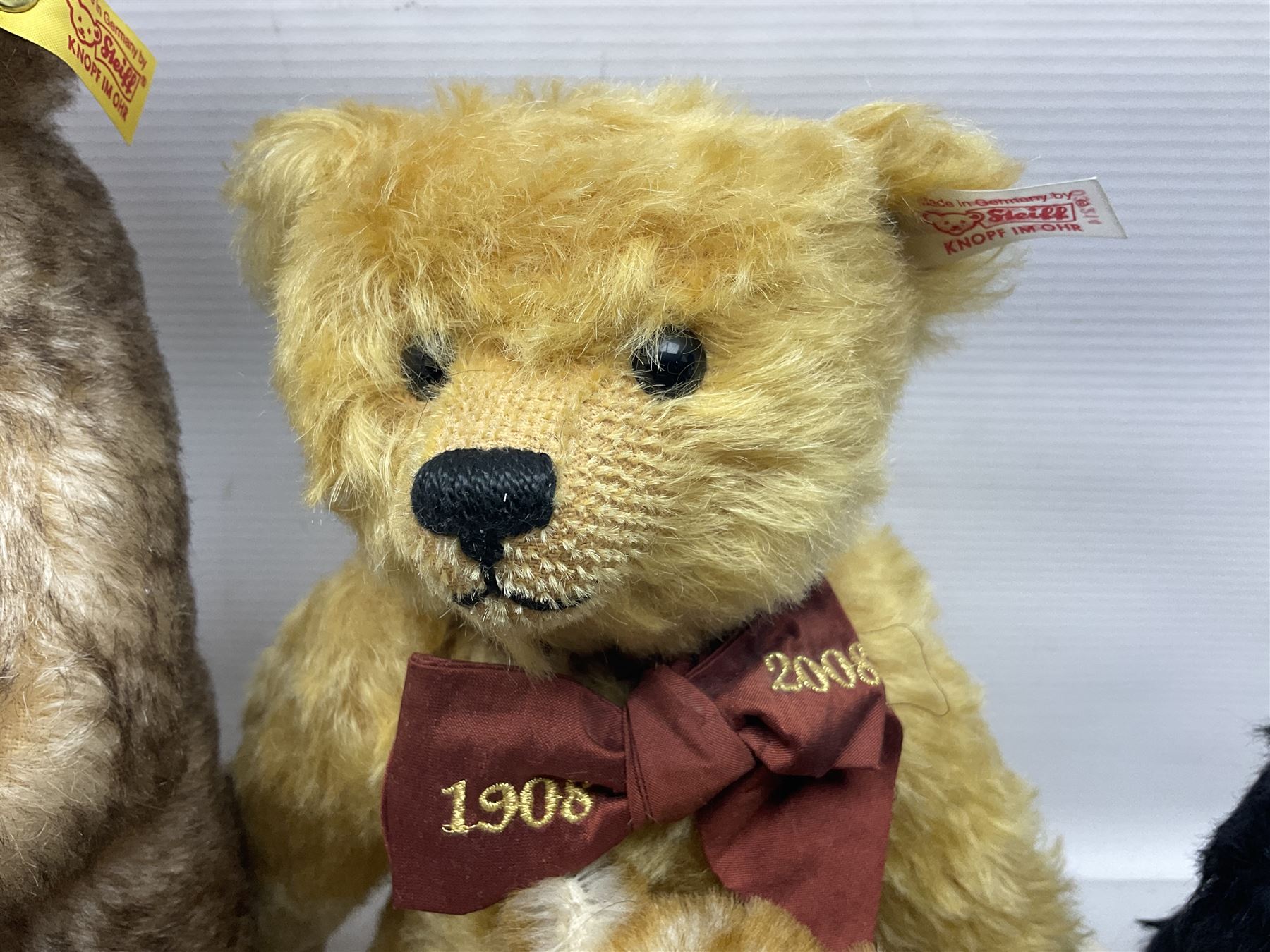 Seven modern Steiff teddy bears comprising two limited edition '1908 Paul the Growler' bears Nos.1124/3000 and 1310/3000; 028649 Classic Teddybear 23; 005992 Classic Teddybear 28 (black); 071249 Mungo Meerkat 30; 079139 Reclining dog for American Kennel Club; and 029561 Petsy gespitzt (1928) 16cm; together with a Mrs. McCatty's limited edition 2156 Sophie bear No.1557/1750; all unboxed but most with labels (8)