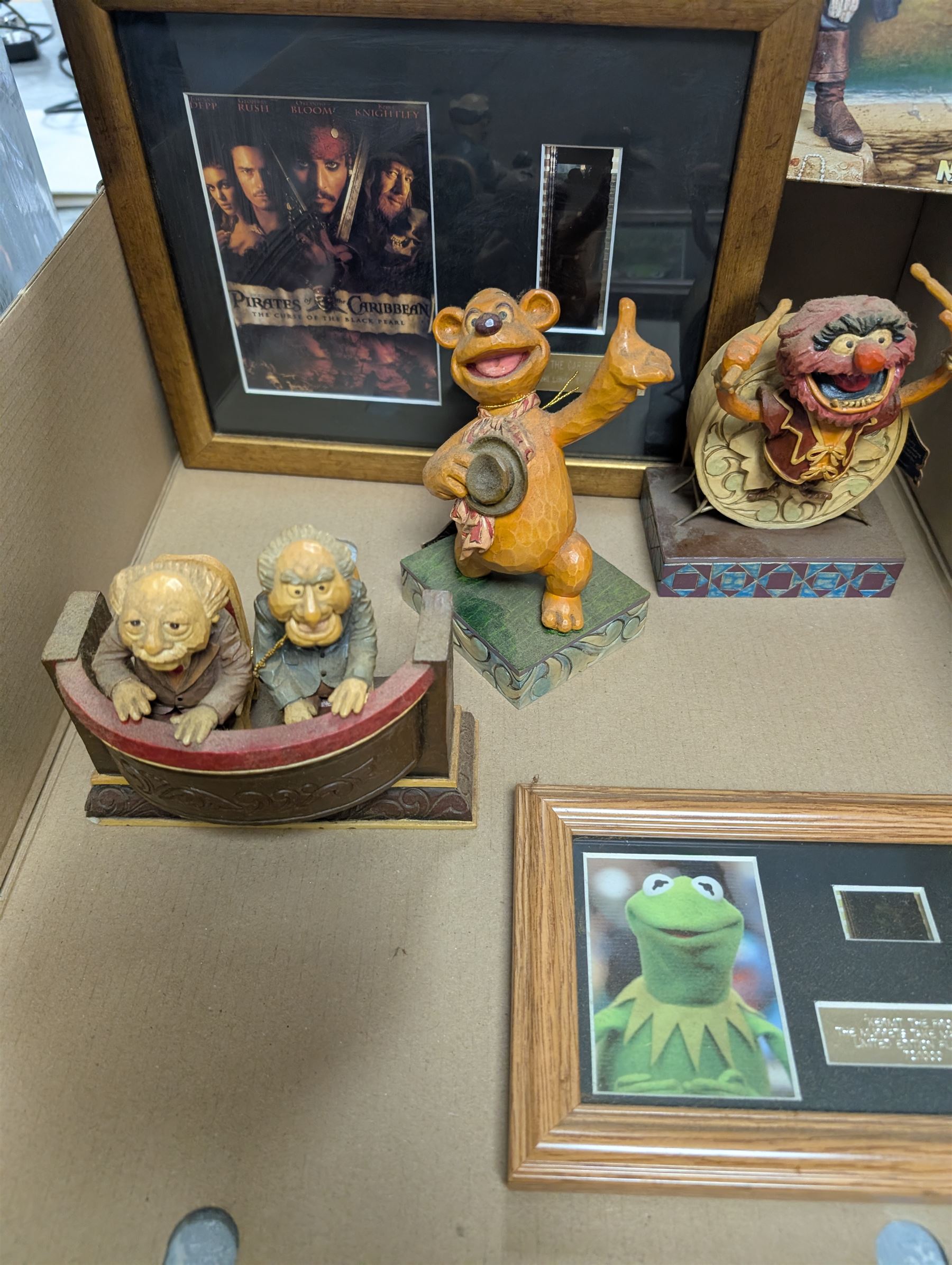 Collection of Disney and similar figures and memorabilia, including Pirates of the Caribbean Capt Jack Sparrow talking figure and NECA toys Jack Sparrow Head Knocker, three Disney showcase figures, Kermit the Frog framed film cell and Tomb Raider figure