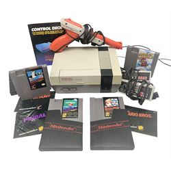 Nintendo Entertainment System (1985) console with two controllers, accessories and instruction booklet. NES Games ‘Duck Hunt’ with Nintendo Zapper gun, ‘Pinball’ and ‘Super Mario Bros.’, all with original sleeves and instruction booklets. NES game ‘Super Mario Bros. 2’ cartridge only