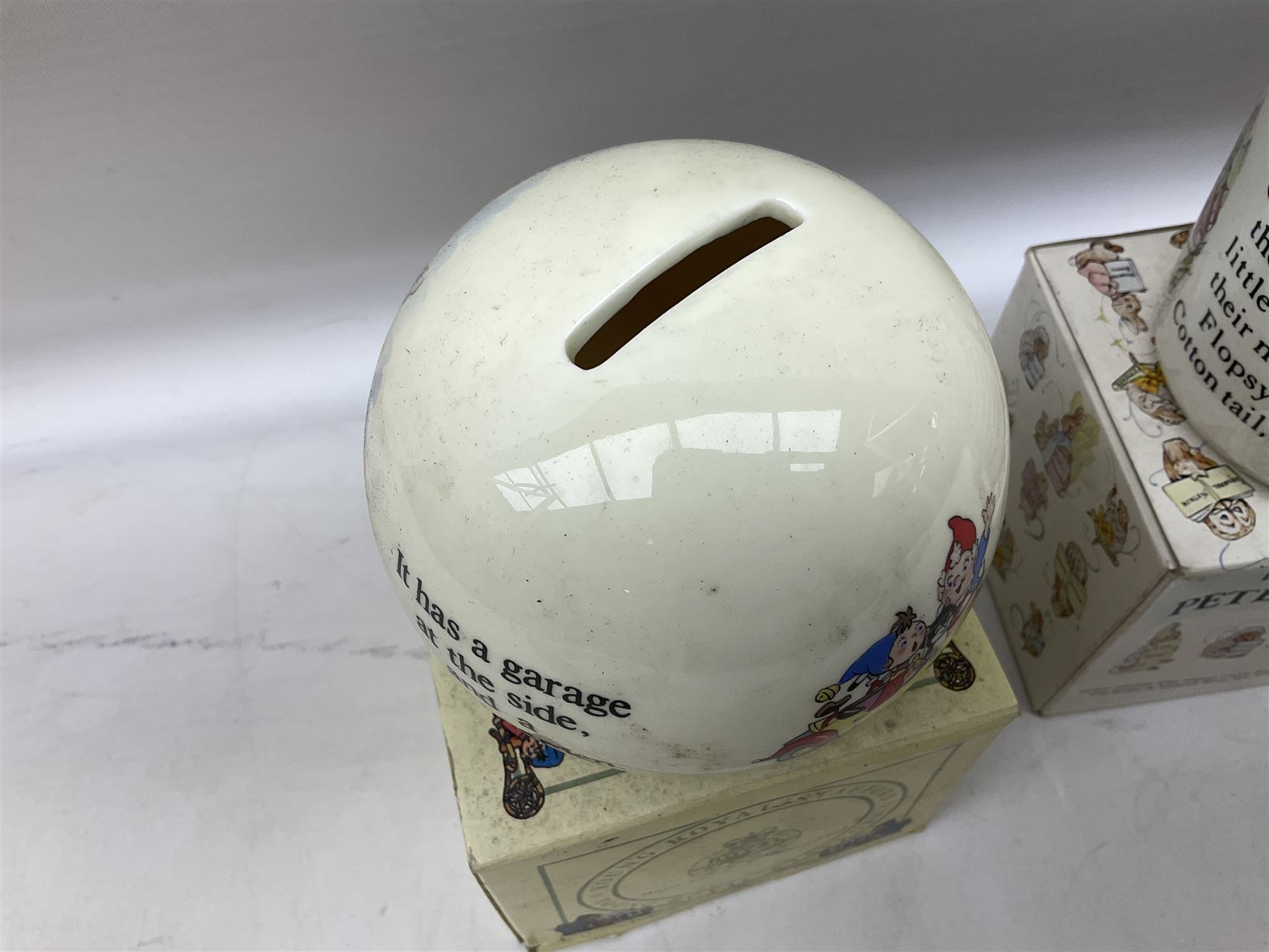 Royal Doulton Bunnykins nursery set in box and two cups, together with two Wedgwood Peter Rabbit mugs and Royal Staffordshire Noddy money box and cup (7)