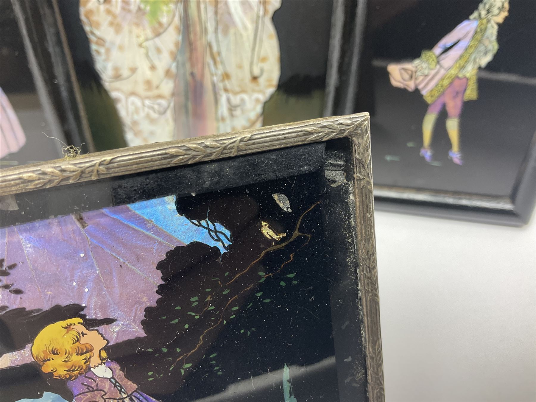 Seven 1930's butterfly wing pictures, mainly of ladies in period dress, one signed Dorothy Buckley, largest H18cm