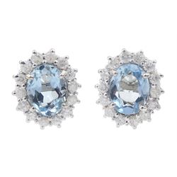 Pair of 18ct white gold oval aquamarine and round brilliant cut diamond cluster stud earrings, hallmarked, total aquamarine weight approx 1.65 carat, total diamond weight approx 0.60 carat