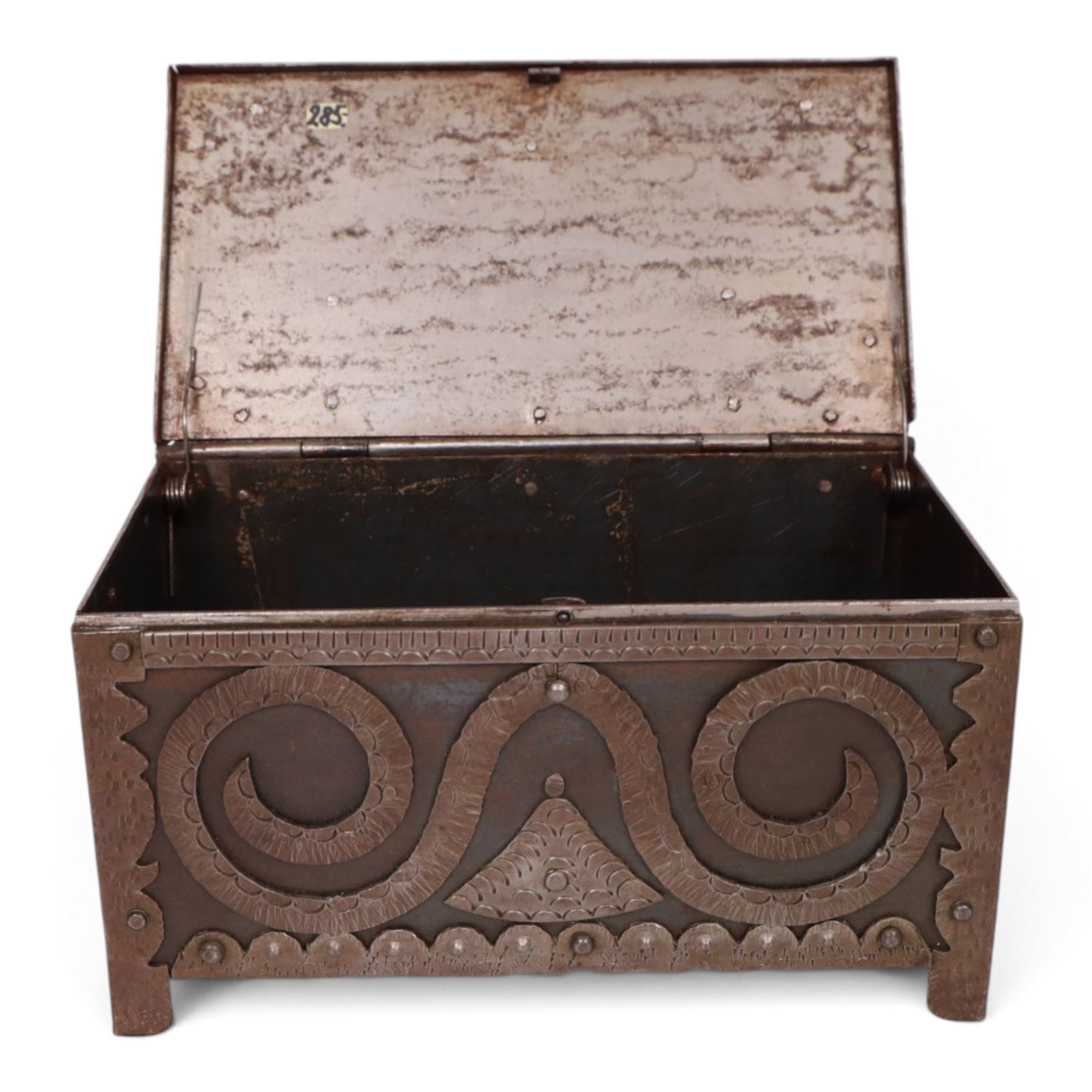 Late 19th/early 20th century vernacular iron box, the hinged cover and sides with applied strapwork decoration, the cover with applied church motif, H11.5cm W22cm D12cm