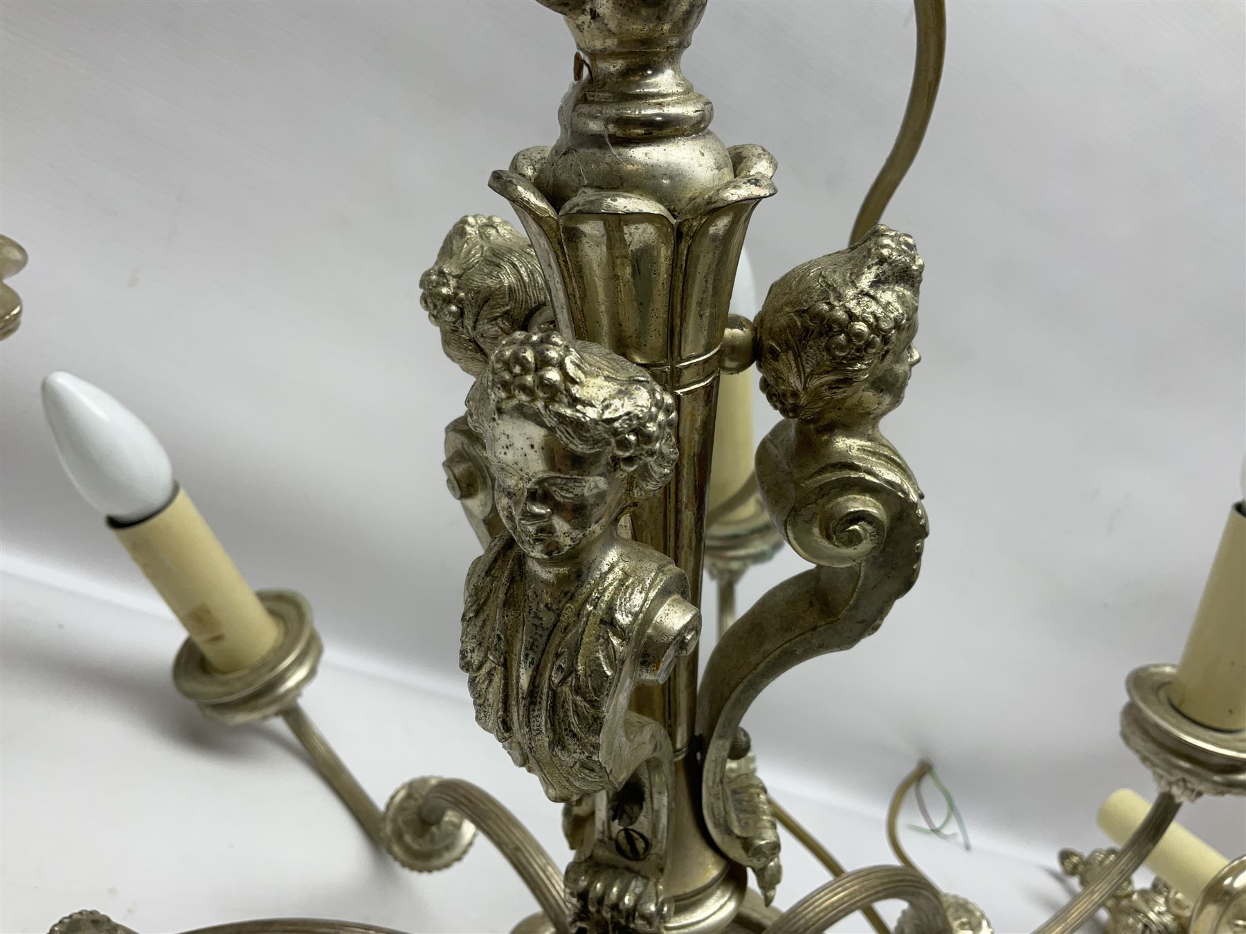 Siz branch silvered chandelier, decorated with acanthus leaves and putti, together with two matching three branch wall sconces, chandelier D65cm