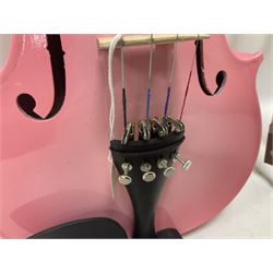 Zest full size pink violin, with a solid wood body and maple head, with matching pink bow and two further bows, in a hard case Length 60cm