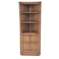  Ercol Golden Dawn finish elm corner cupboard, two shelves above single cupboard, platform base, W76cm, H183cm, D43cm  