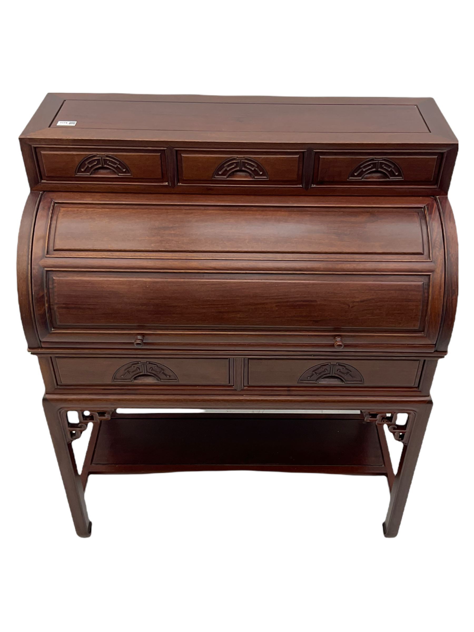 Hardwood cylinder desk, three drawers raised over curved lid, fitted interior with slide, the supports joined by undertier with fret work brackets 