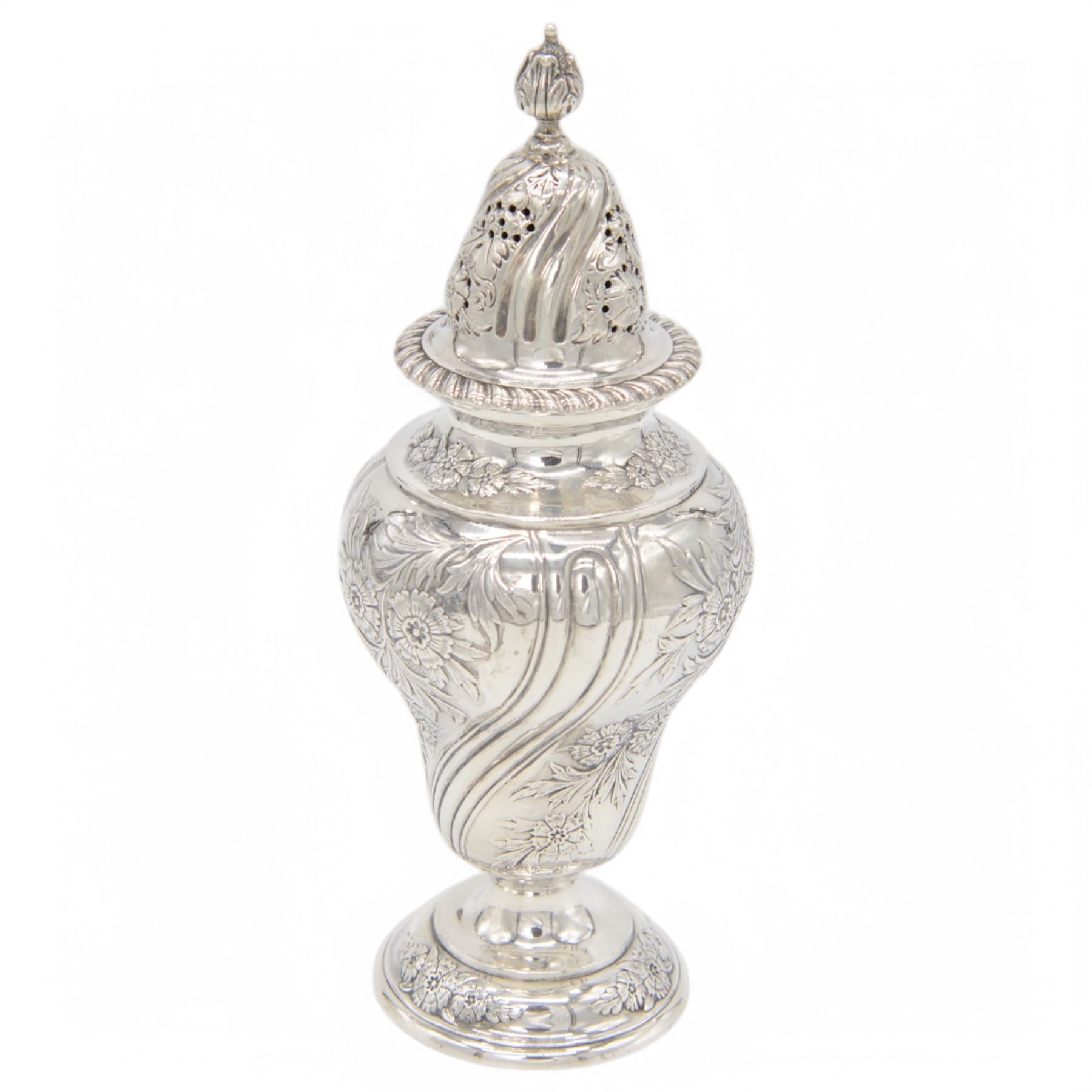 Edwardian silver sugar caster, of typical form embossed with floral decoration, the removable pierced cover with oblique gadrooned rim and bud finial, upon a circular stepped foot, hallmarked Hawksworth, Eyre & Co Ltd, London 1901, H20cm
