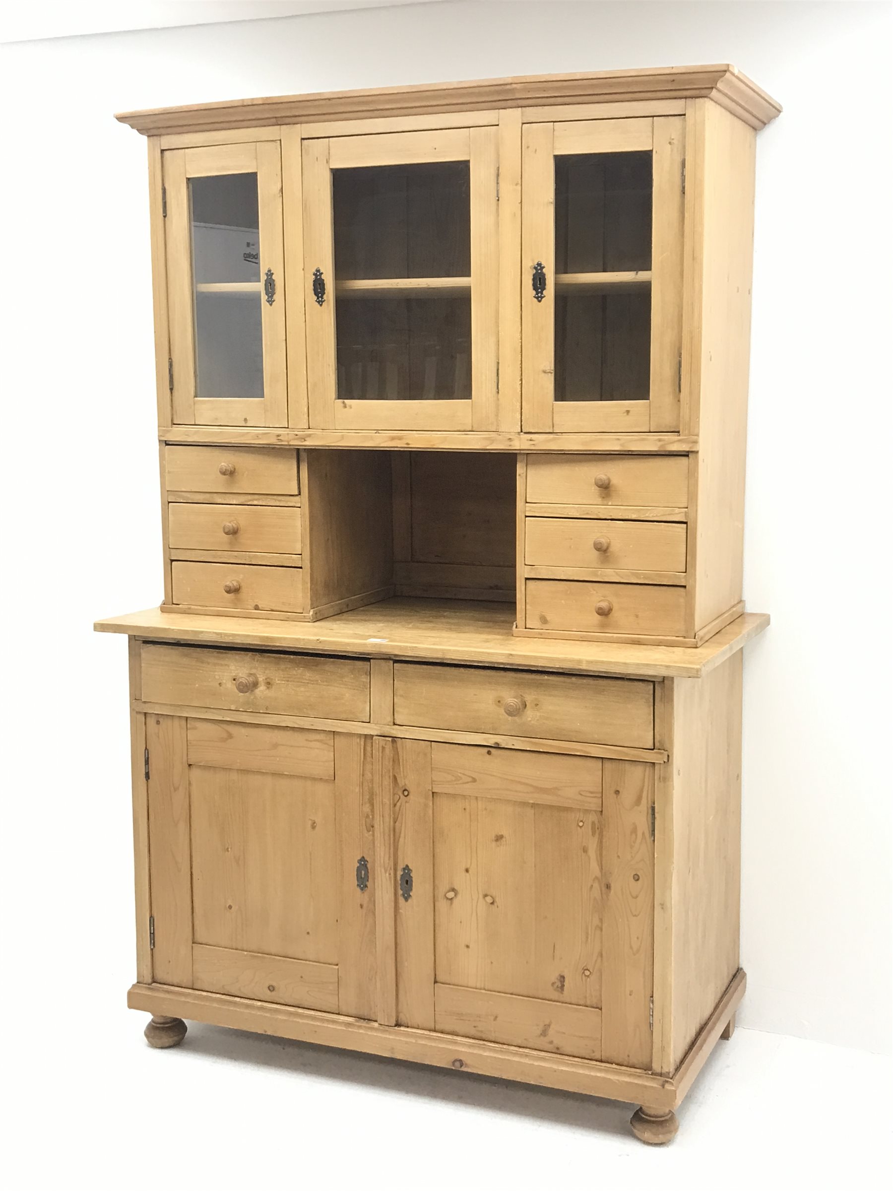 Early 20th century pine kitchen cupboard, raised glazed cabinets with drawers, lower section fitted with two drawers and panelled double cupboard, turned feet,  W127cm, H195cm, D62cm
