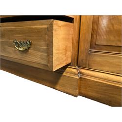 Edwardian walnut combination breakfront triple wardrobe, projecting cornice over cushioned and fluted frieze, central fielded panelled cupboard carved with foliate decoration above two short and three long drawers, flanked by two bevelled mirror doors enclosing hanging hooks with single drawers to base, retailed by J Tonks & Sons, Scarborough