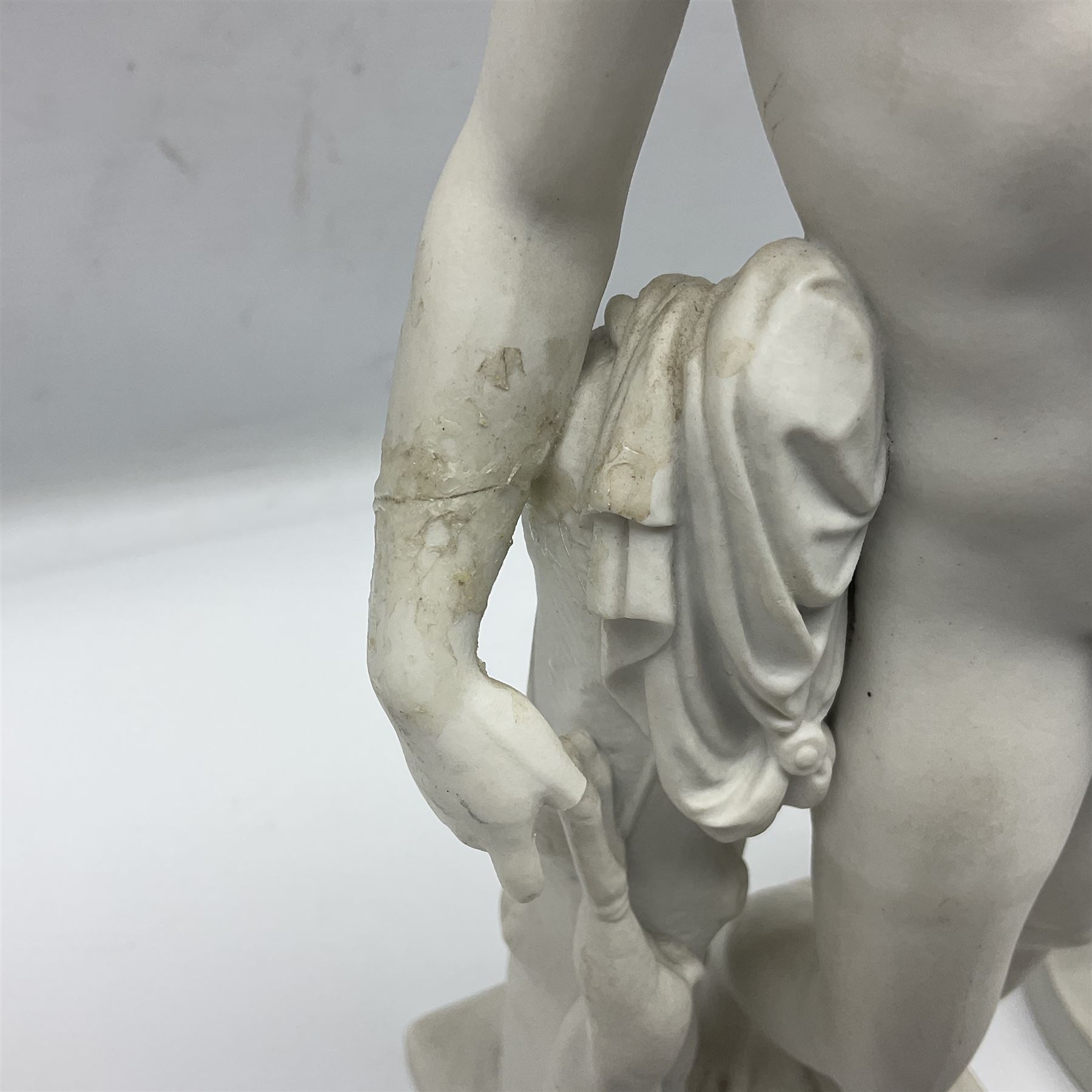Royal Copenhagen Parian ware figure, modelled as Adonis, standing contrapposto by a tree trunk, together with a similar Parian ware figure, modelled as Venus with the Apple, both after Bertel Thorvaldsen and stamped Eneret to base with blue wave marks beneath, tallest H31.5cm