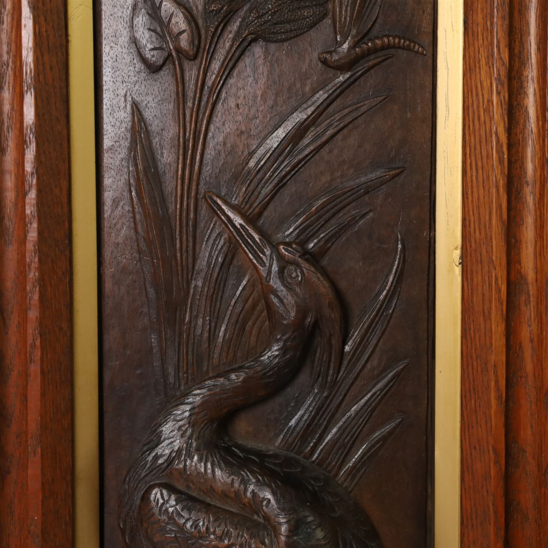 After Leander Plummer II, carved wooden panel of a stork amongst reeds, within a wooden frame, H80cm