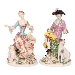 Pair of 19th century Samson figures, the gentleman wearing a wide brimmed hat with a dog, the lady with a sheep by her side, both figures seated upon a floral encrusted pillars with gilt scrolling base, H22cm
