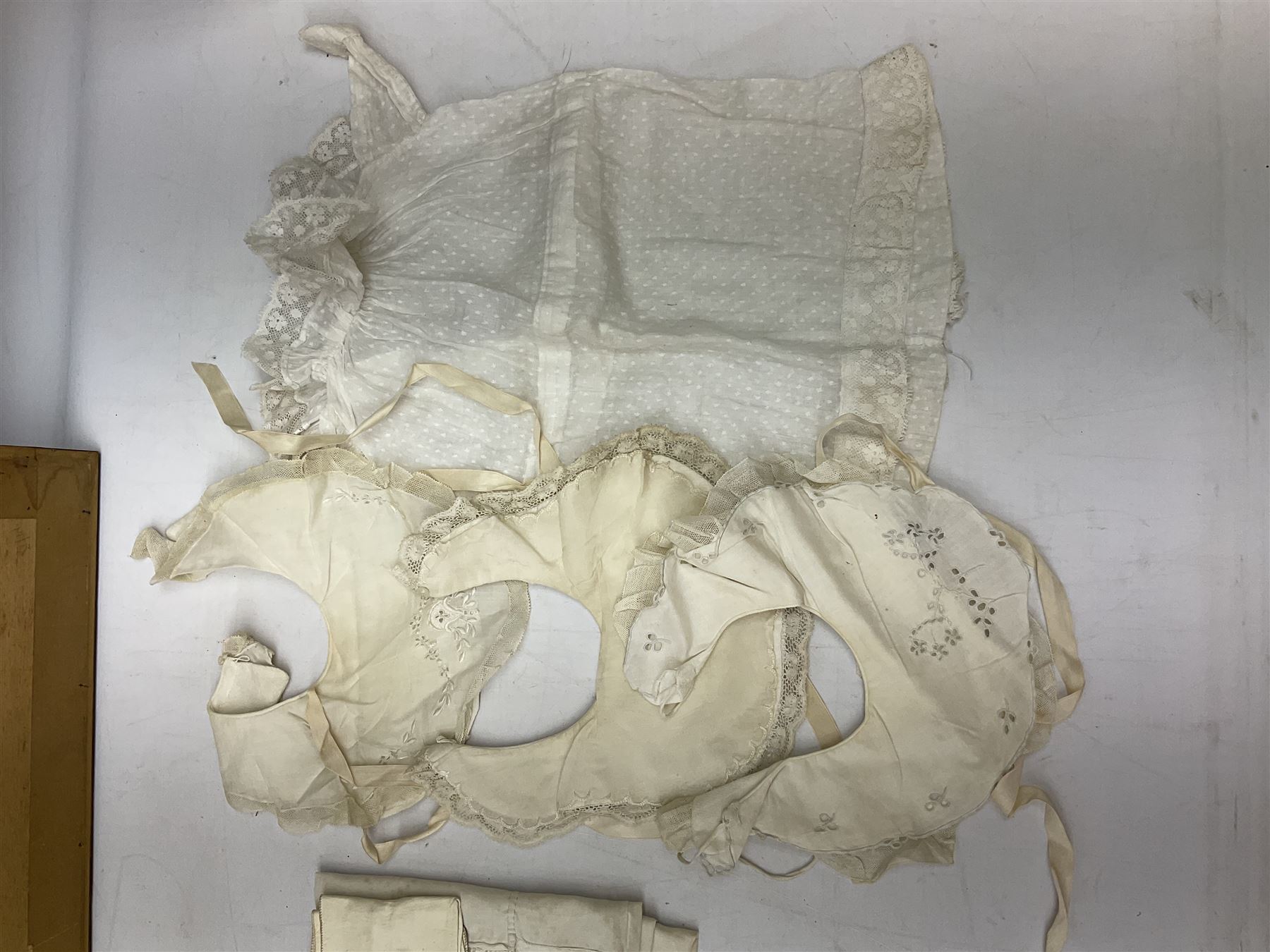 Late 18th century sampler worked with the alphabet above verses in red, by Mary Birkett aged 10 November 16th 1792, H33.5cm W34.5cm, together with another sampler worked with the alphabet above Proverbs 14:23, by Mary Anne Hainworth, Chesham, date unknown (--83), both in glazed frames, together with a quantity of Victorian and later dolls clothes to include lace examples