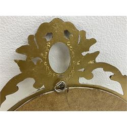 Ornate brass wall mirror with oval plate, L78cm