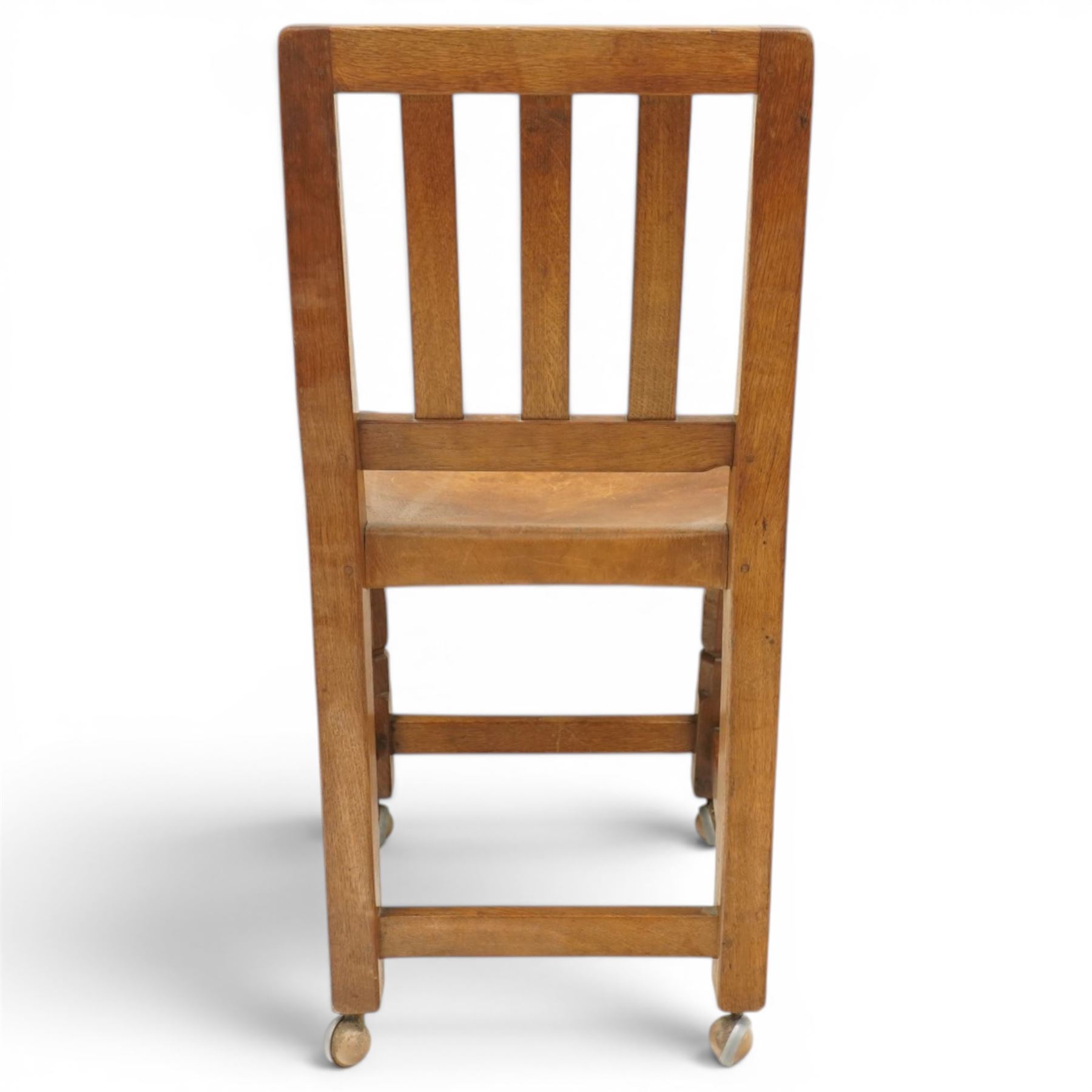 Mouseman - 1940s oak side chair, the slat-back over a slung leather seat, raised on octagonal front supports united by box stretcher, carved with slim mouse signature, by the workshop of Robert Thompson of Kilburn