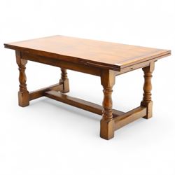 20th-century good quality solid oak extending refectory table, planked, constructed rectangular top with two extending leaves on the underside above a plain frieze raised on four turned baluster supports united by stretchers on block feet, 260cm extended