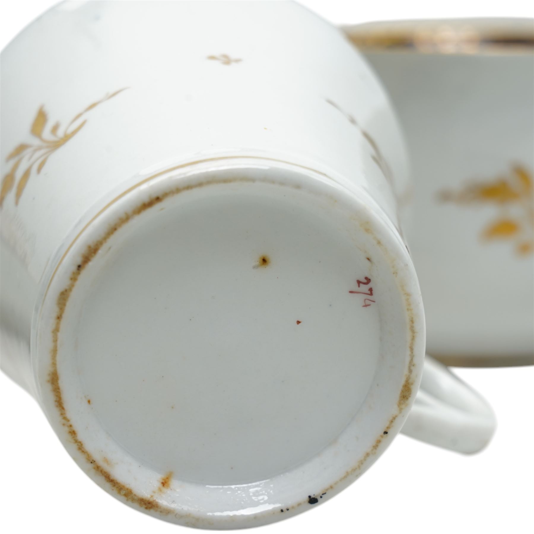  19th century Coalport Felt Spar porcelain cup and saucer painted with panels of flowers on a green and gilt ground and marked I Rose & Co and an early 19th century Worcester trio decorated in blue and gilt, Pattern No.274 