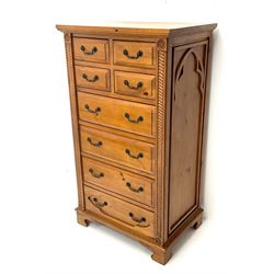 Gothic pine chest fitted with four short and four long drawers, rope twist carving, shaped bracket supports