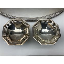 Pair of Mappin and Webb silver plate pierced pedestal bon bon dishes, together with other silver plate comprising teapot stand engraved with lion's head to centre, two cut glass claret jugs, two bottle coasters with acorn decoration, two open salts upon dolphin mounts, tea caddy, three piece cruet set and a large oval tray with pierced sides and upon four ball feet