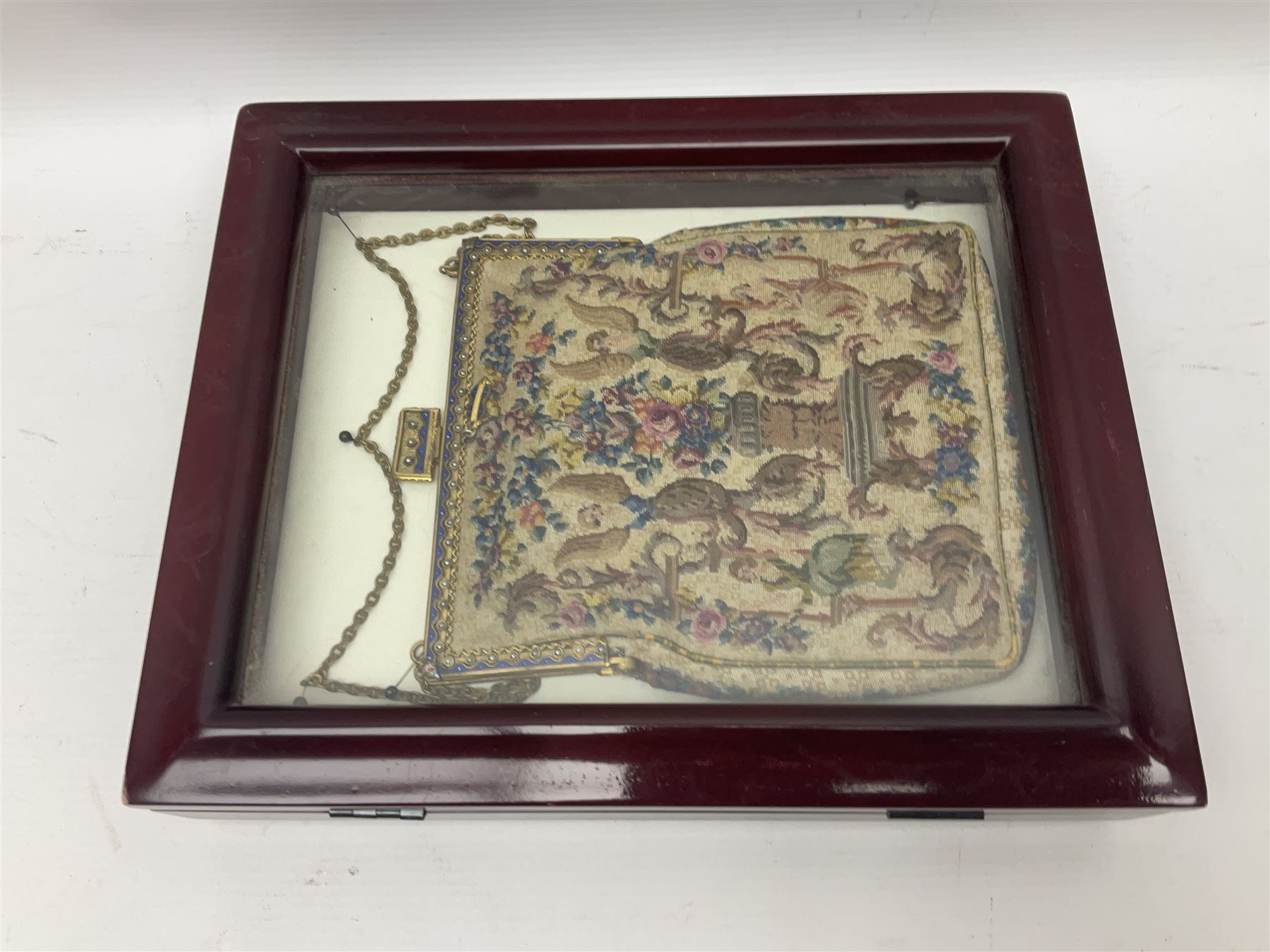 Continental petit point evening bag, with enamel and pearl details, in wooden display frame, together with a snake skin handbag and three other vintage bags