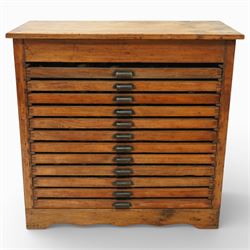 20th century oak printers cabinet, the rectangular top over a bank of twelve shallow drawe...