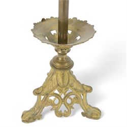 Pair of late 19th century gilt cast candelabra, each with scrolling tripartite base leading to an acanthus detailed circular pan and plain stem, supporting three arms entwined with lily flowers and leaves, the sockets also modelled as lily flowers, H60cm