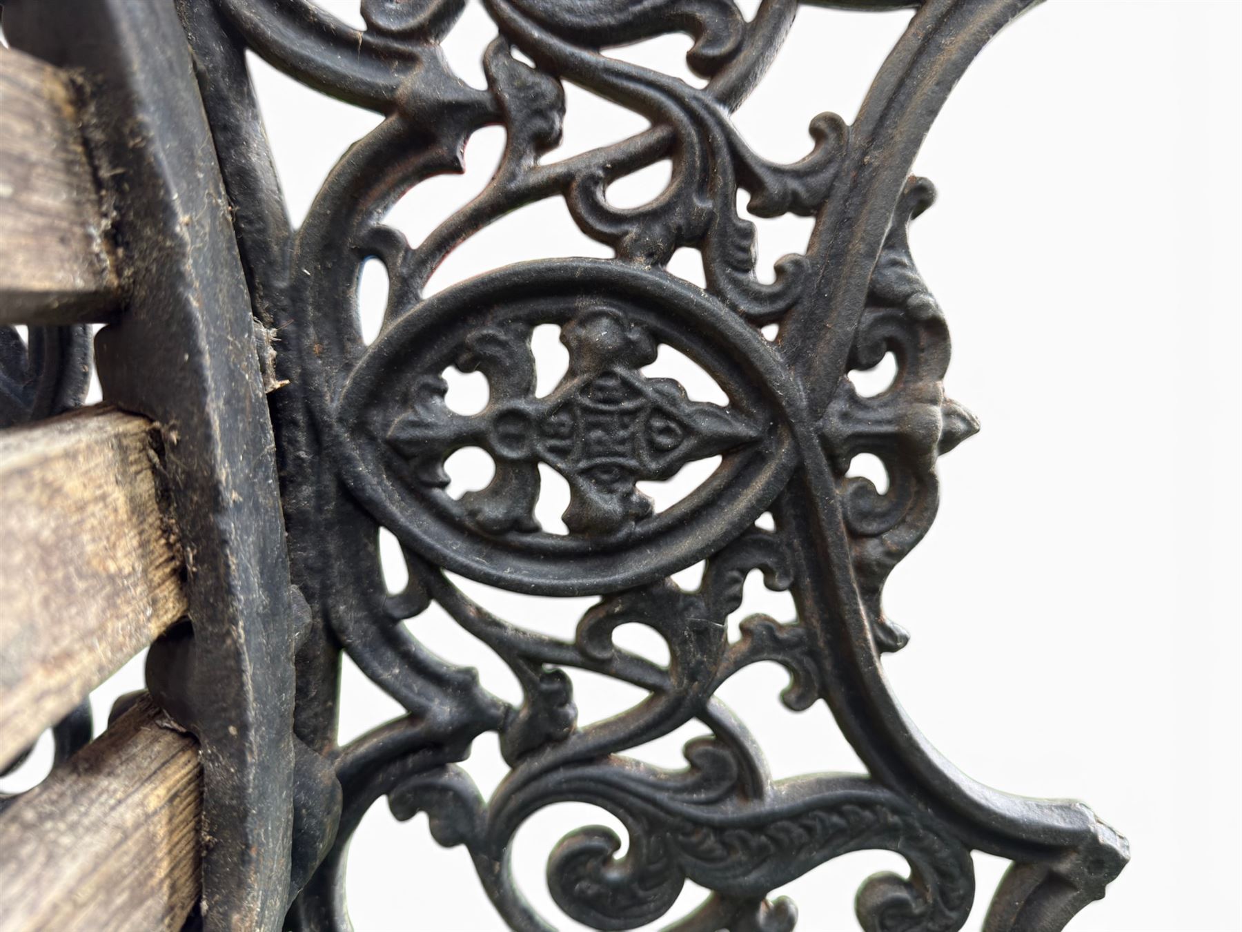 Victorian Andrew McLaren pattern cast iron bench, the ornate ends with detailed scrollwork, joined together with a cast iron seat and backrest frame supporting gently weathered oak slats, Victorian diamond stamp mark