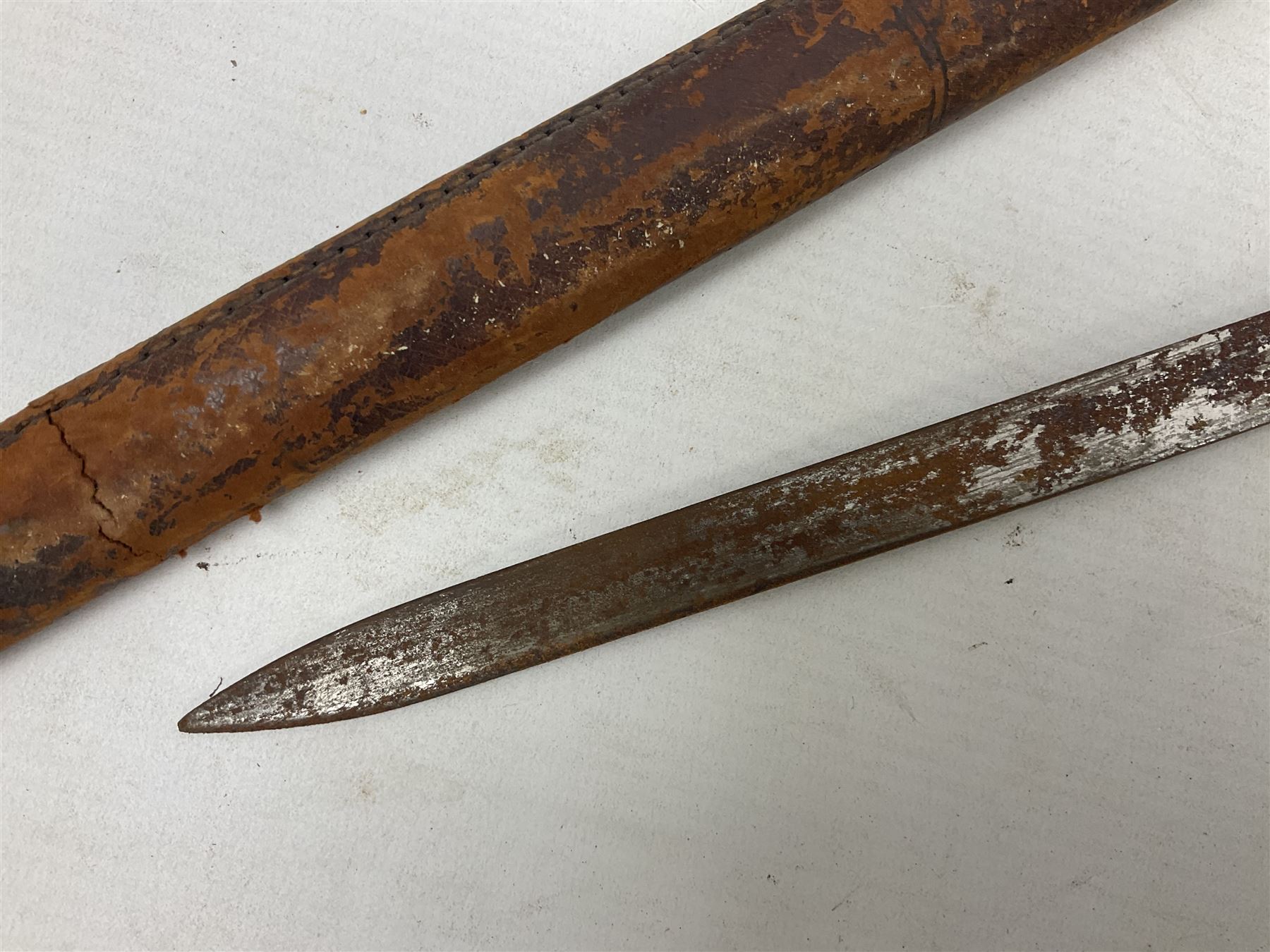 George V 1897 pattern Infantry officers sword, the 82cm single fullered blade with traces of etched detail and George V crown cipher, the ricasso marked Hawksworth Sheffield, pierced half basket hilt with George V cypher, wire-bound fish-skin grip with brass pommel and backstrap; in leather scabbard L102cm overall; together with two sectional gun cleaning rods; swagger stick made of leather strips etc