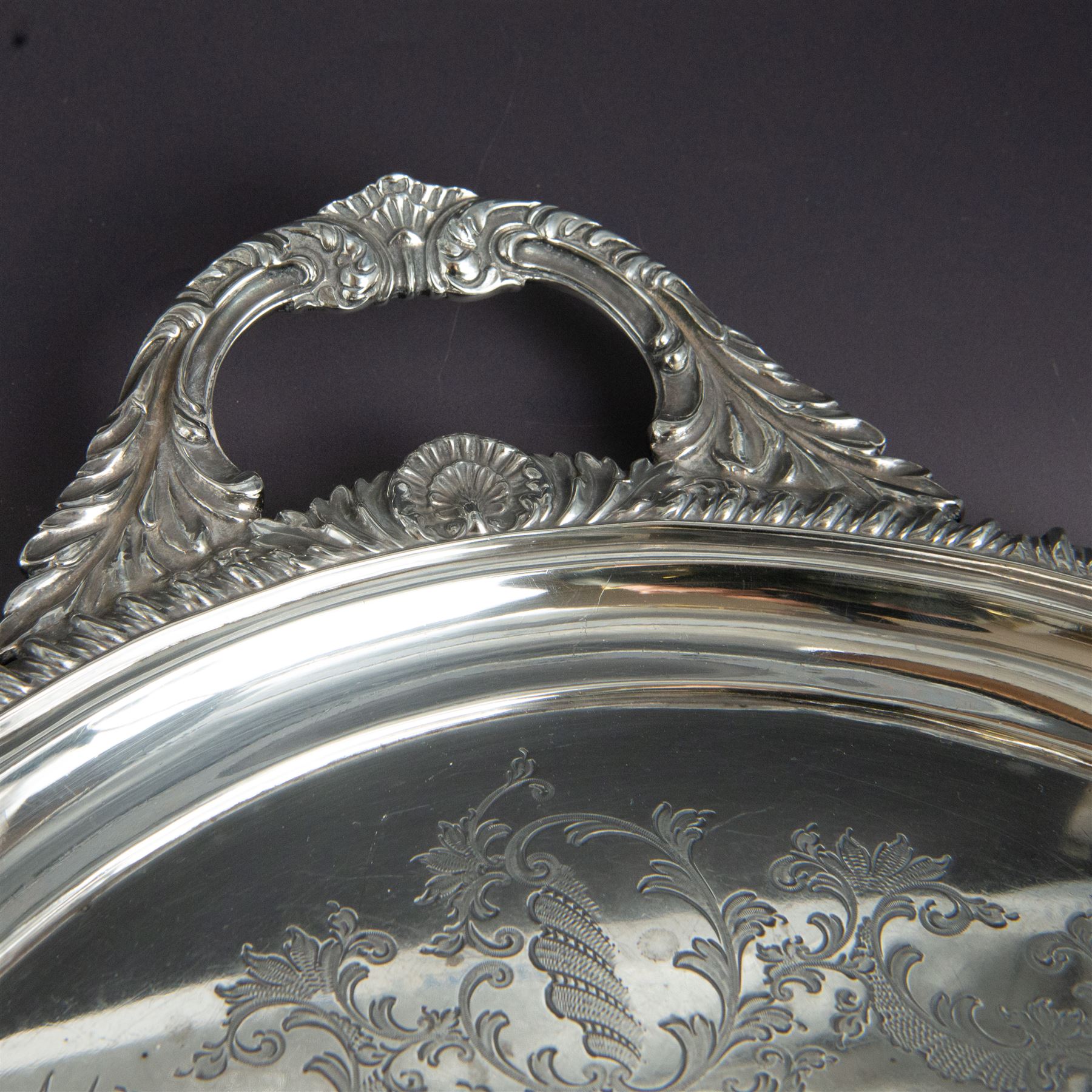 Victorian silver twin handled tray, of oval form, engraved with floral and foliate swags with vacant cartouche to centre, with oblique gadrooned rim, palmette details and foliate decoration to handles, hallmarked Atkin Brothers, Sheffield 1901, handle to handle W70cm