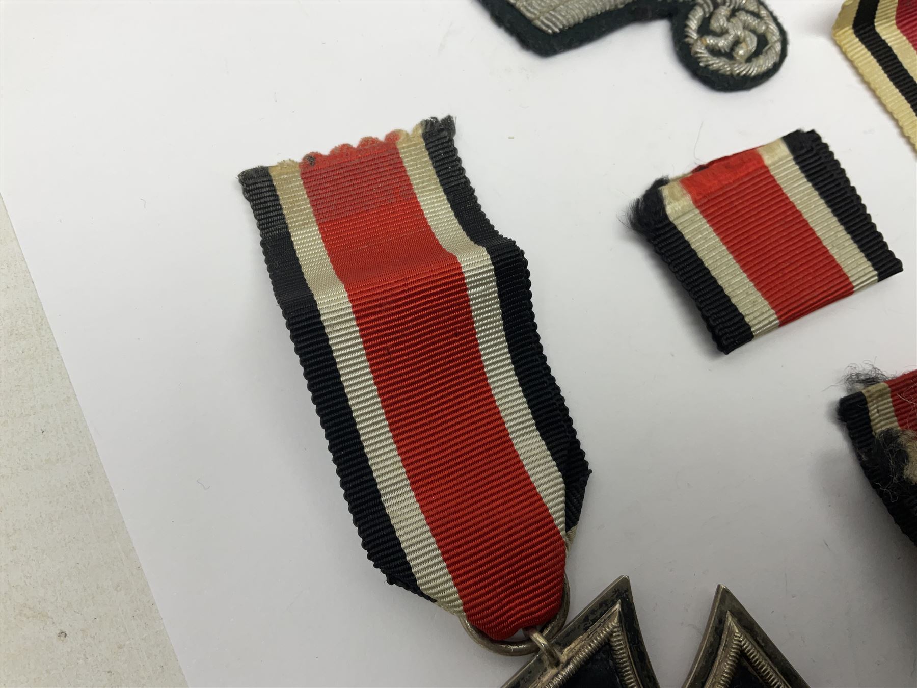 WWII German Iron Cross 2nd Class, the suspension ring stamped 128 for S. Jablonski G.m.b.H. Posen; with ribbon; together with an embroidered cloth eagle badge and quantity of German medal ribbons.