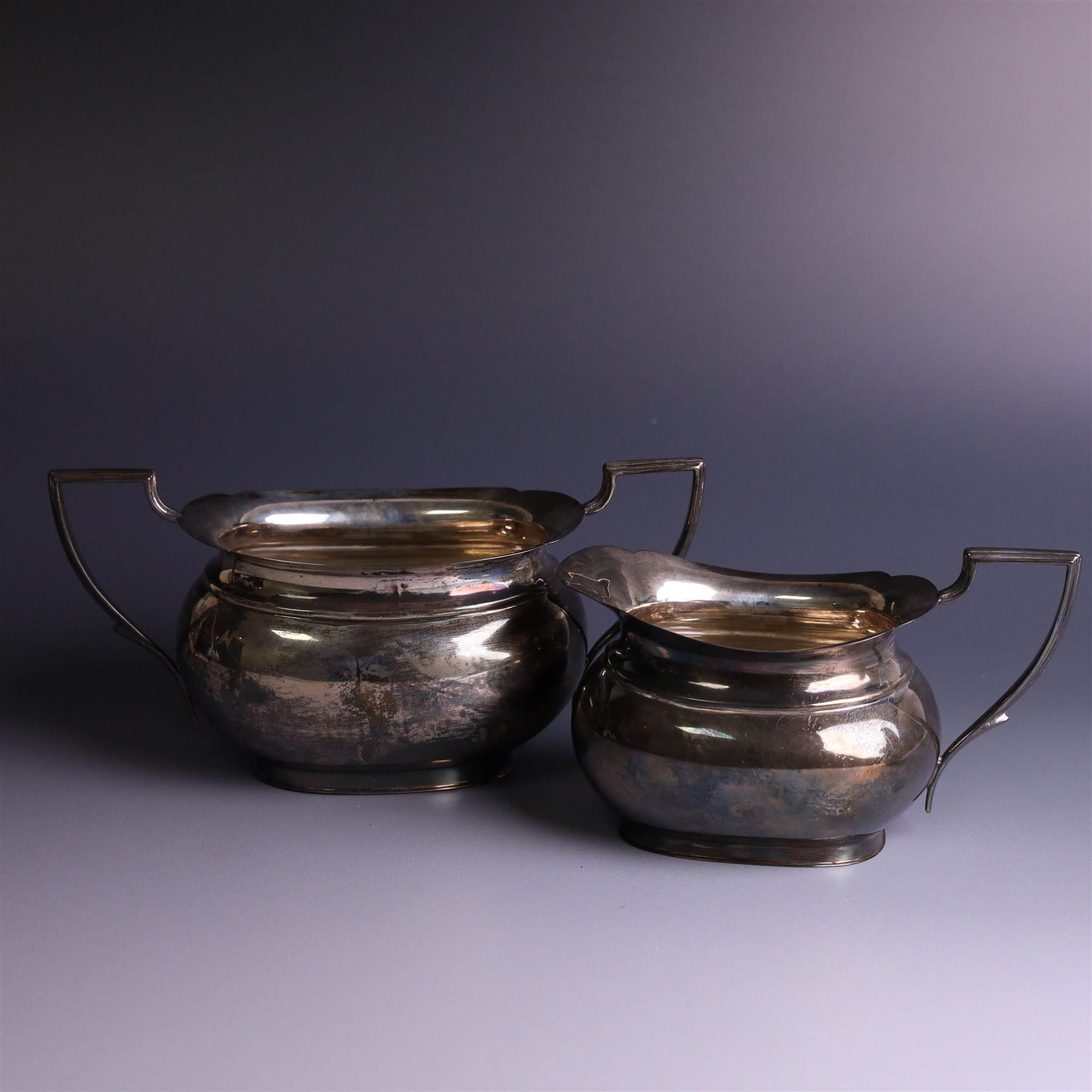 1930s three piece silver tea service, comprising teapot with wooden handle and finial, open sucrier and milk jug, hallmarked Viners Ltd, Sheffield 1930