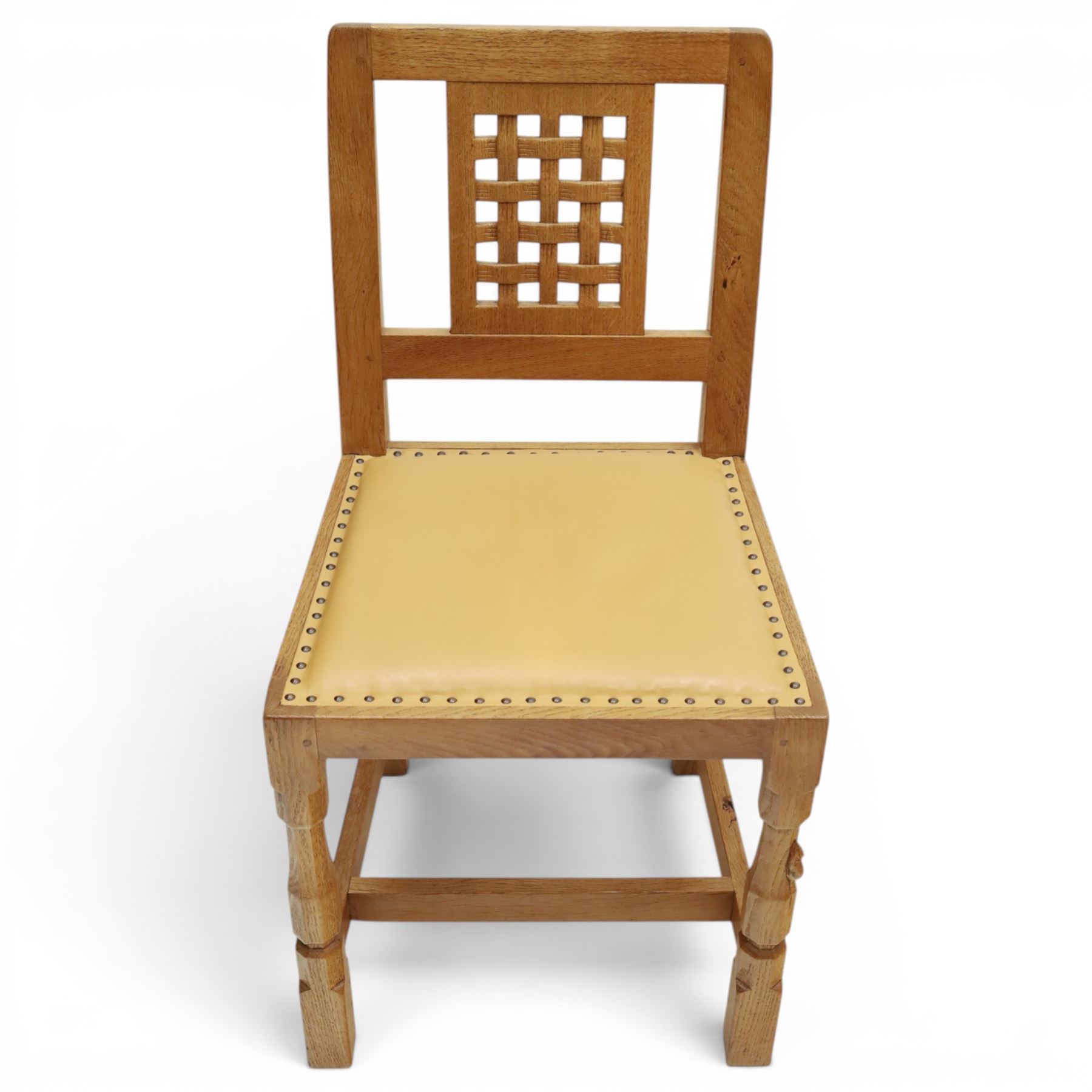 Mouseman - set of eight light oak dining chairs, each with lattice panel back and tan leather upholstered seat, raised on octagonal front legs joined by stretchers, with signature carved mouse, by the workshop of Robert Thompson, Kilburn