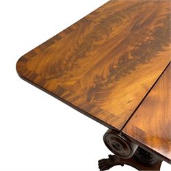Unusual William IV mahogany Sutherland table, figured and book-matched rectangular drop-leaf top on cylindrical barrel movement, turned roundels to each end, on turned pedestal with acanthus carved baluster, shaped platform with four extended paw feet