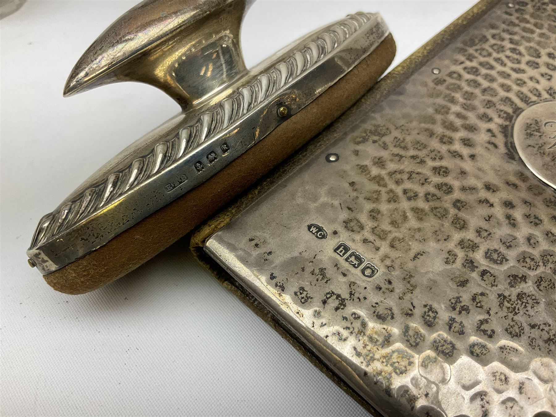 Edwardian silver mounted purse, with circular panel engraved with initials, and hammered finish, hallmarked William Comyns & Sons, London 1903, H14cm, together with three dressing table glass jars with hallmarked silver covers, and a hallmarked silver mounted buffer 