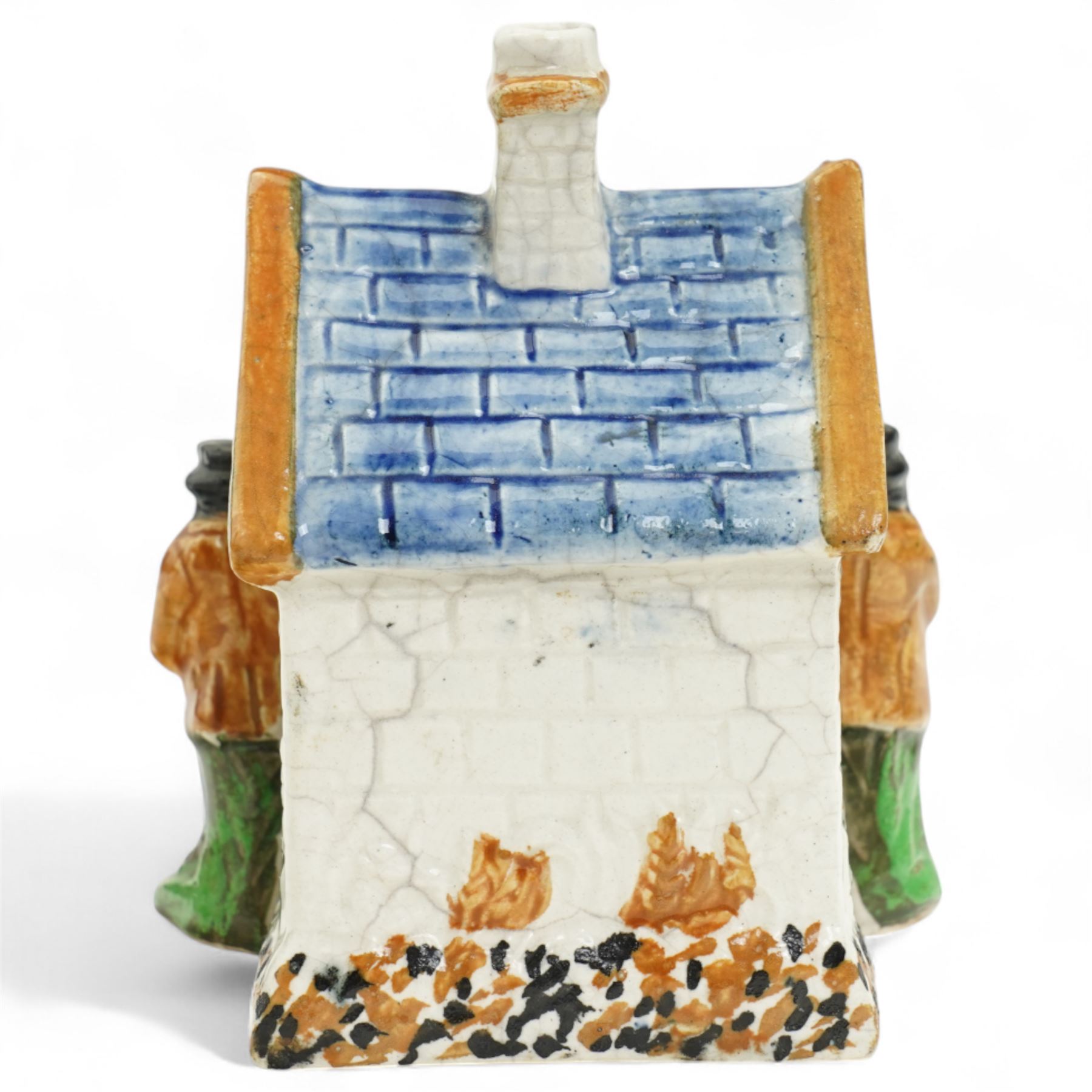 Yorkshire Prattware cottage, circa. 1820, in shades of blue, ochre and white, moulded in relief with two flanking gentlemen figures, H12cm 