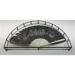 Hand painted feather and bone fan painted with figures and floral detail, in a semicircular glass display case L49.5cm. 