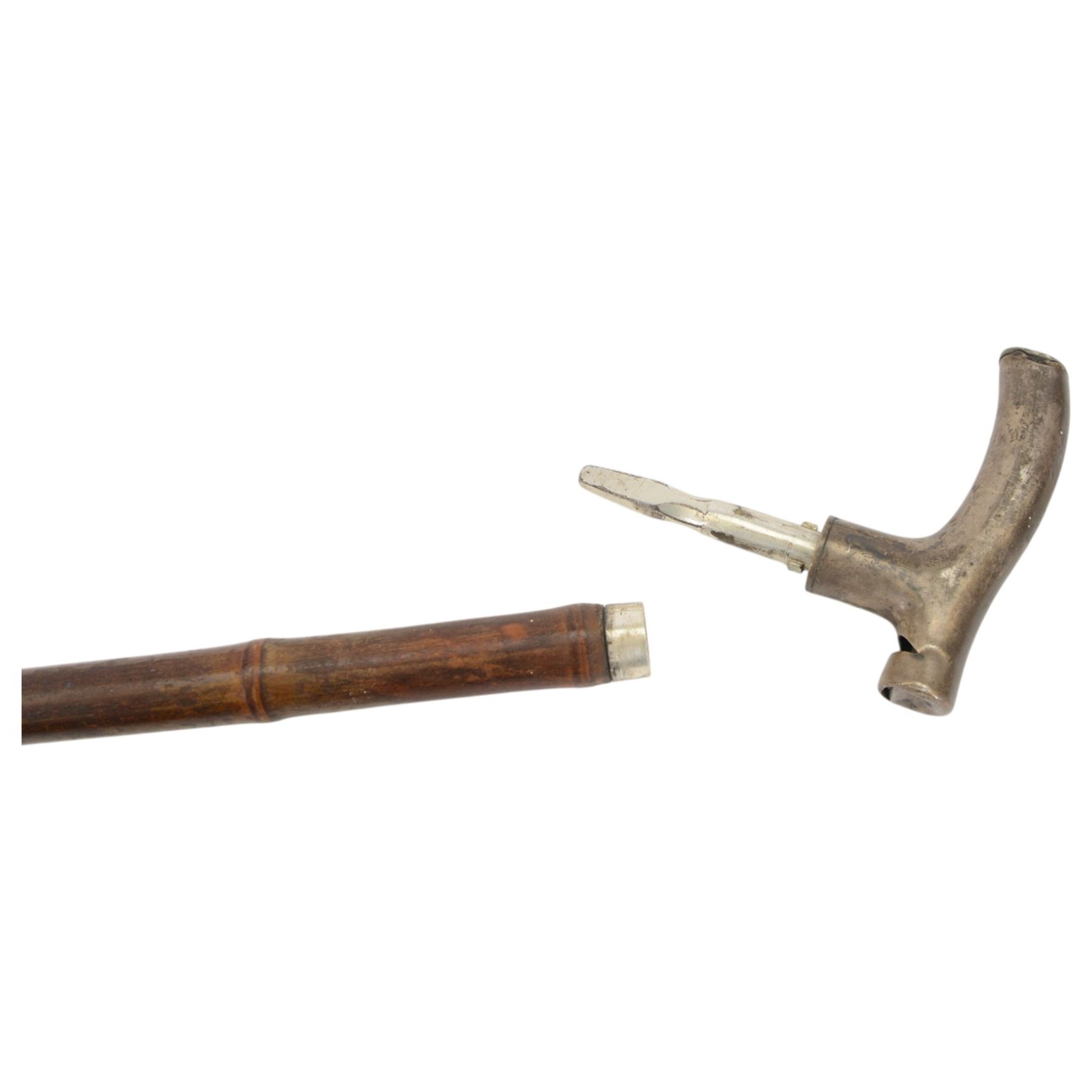 20th century novelty walking stick, the L-shaped metal handle as a whistle, bamboo cane, together with another novelty walking stick hardwood stick topped with a metal handle engraved A. Nutt, the top unscrewing to reveal an inner compartment containing a metal Irish flute, largest L96cm 