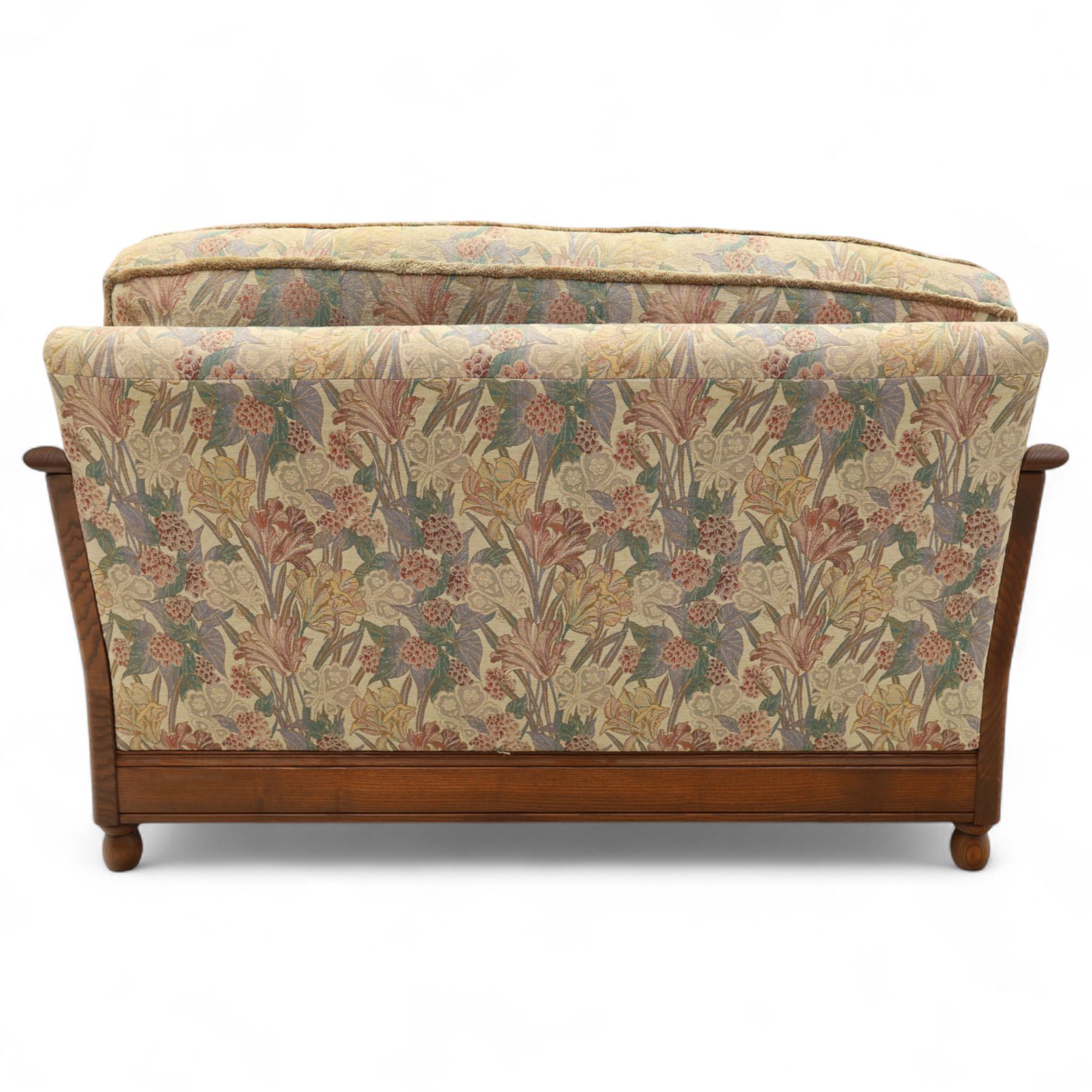 Ercol – bergère four piece suite, including armchair, two seat sofa, three seat sofa and footstool, all with removable floral upholstered cushions, the frames with side caning and rounded arm supports in stained beech

Three seat (H 87cm, D 89cm, W 196cm)
Two seat (H 87cm, D 89cm, W 137cm)
Armchair (H 87cm, D 89cm, W 87cm)
Footstool (H 28cm, D 55cm, W 55cm)