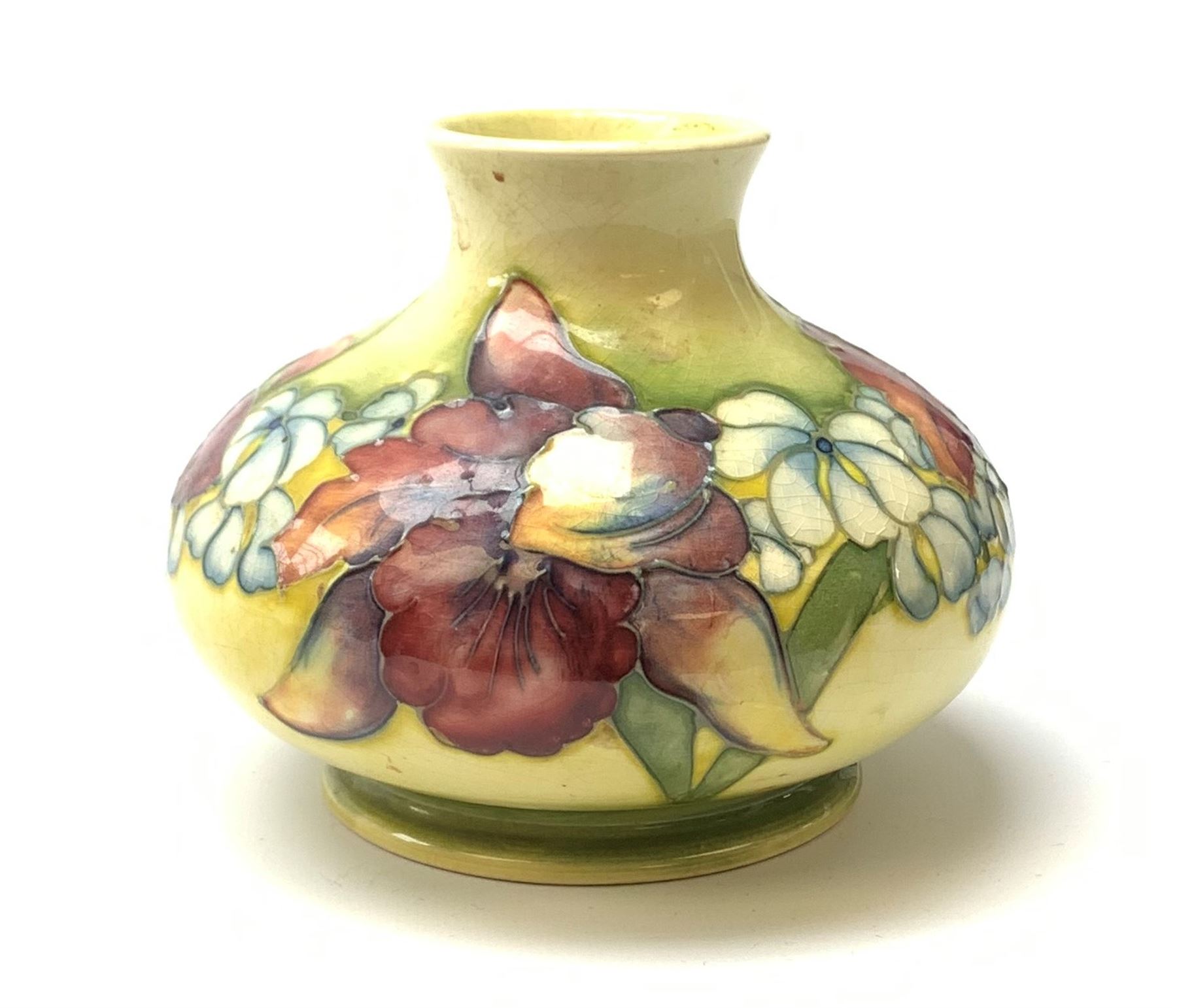 A Moorcroft vase, circa 1950, of squat bulbous form, decorated in the Orchid pattern upon a yellow glazed ground, with impressed and blue painted WM initials for Walter Moorcroft, H10.5cm. 