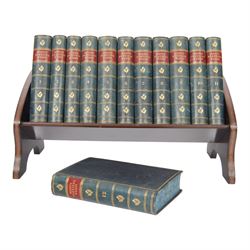 Edwardian book trough, the serpentine ends with boxwood stringing, pierced foliate keyhole shaped detail, and integrated shaped supports, housing Scott, Sir Walter, Poetical Works, Edinburgh, 1868, 12 vols, book trough 18.5cm x 38cm x 22.5cm
