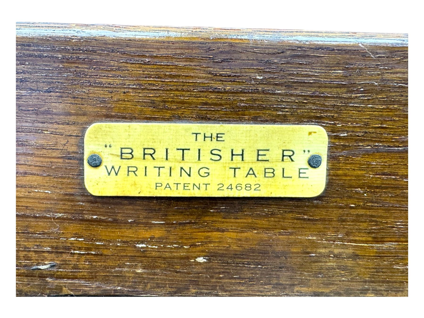 Edwardian oak metamorphic 'Britisher Writing Table', rectangular hinged top revealing correspondence compartments and hinged writing surface with underside storage, flanked by twin hinged compartments with dividers, on turned supports