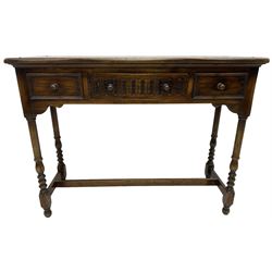 Medium oak side table, rectangular top over three drawers, on turned supports united by H-shaped stretcher rails 