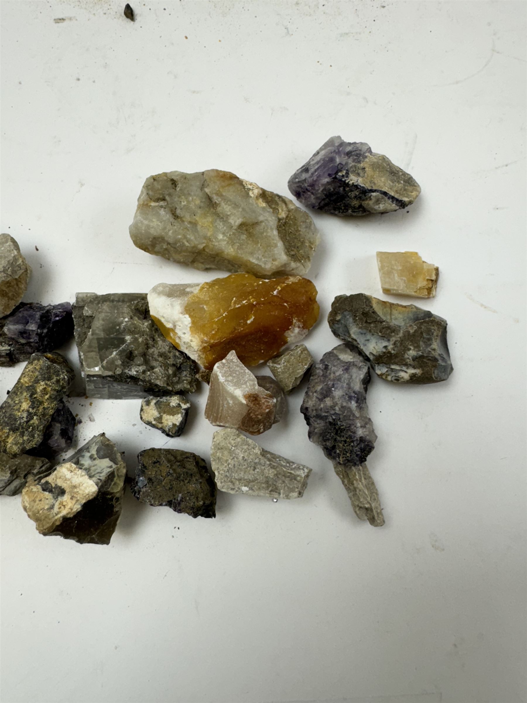 Collection of raw Blue John specimens, together with other mineral specimens