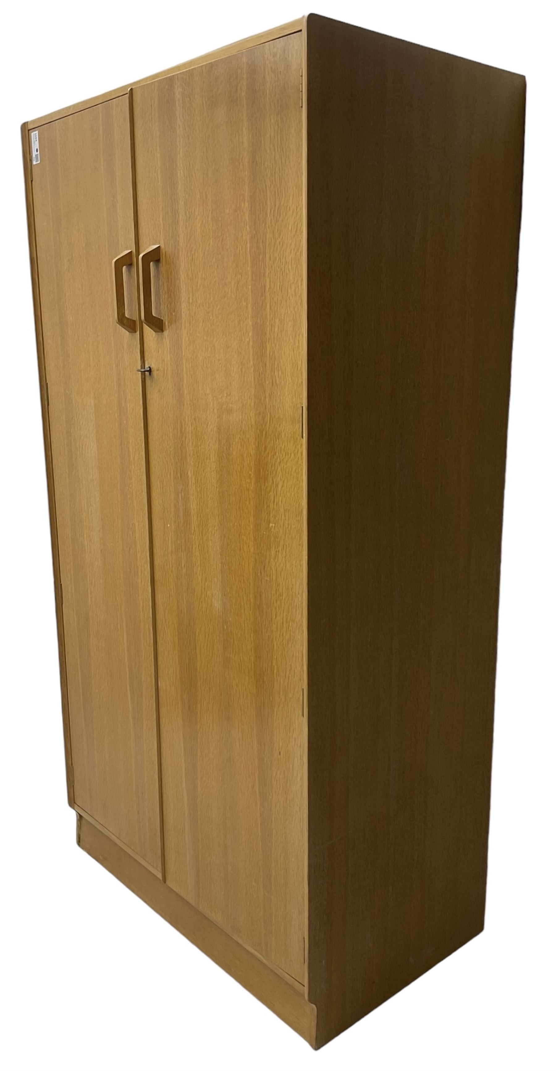 E. Gomme for G-Plan - 'Brandon' light oak double wardrobe, the interior fitted with hanging rail and shelves 