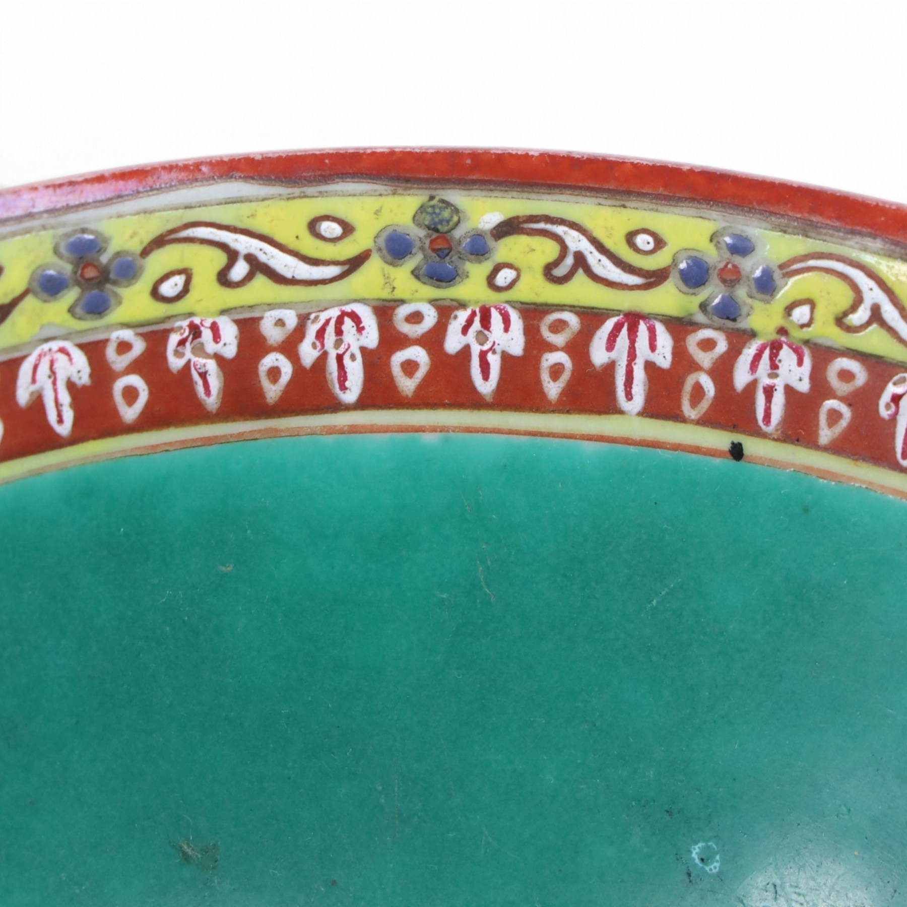 Benjarong bowl, the sides painted with alternating images of the Buddhist figures on a black ground embellished with flames, H8cm D15cm